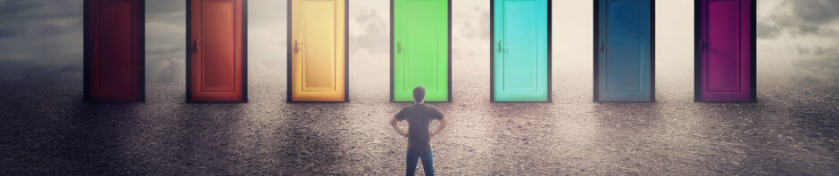 Guy in front of seven colored doors